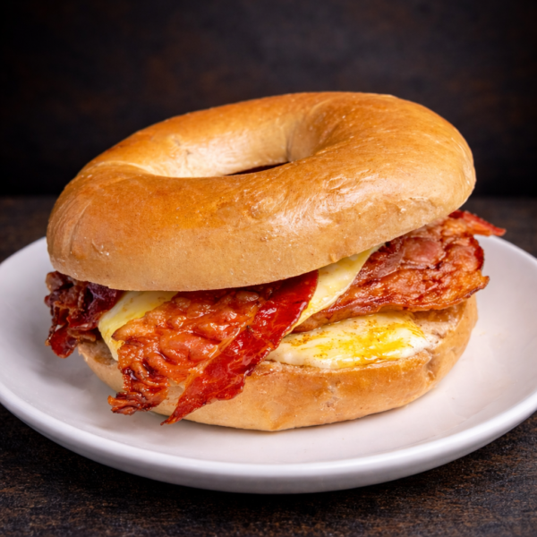 French toast bagel with egg sausage bacon and maple drizzle